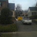 Man on Ladder on Dumpster