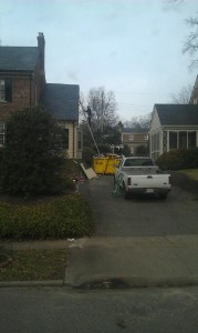 Dumpster propping up ladder