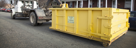 A River City Rubbish yellow roll-off dumpster rental
